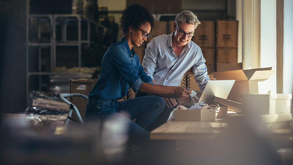 man woman business partners working laptop