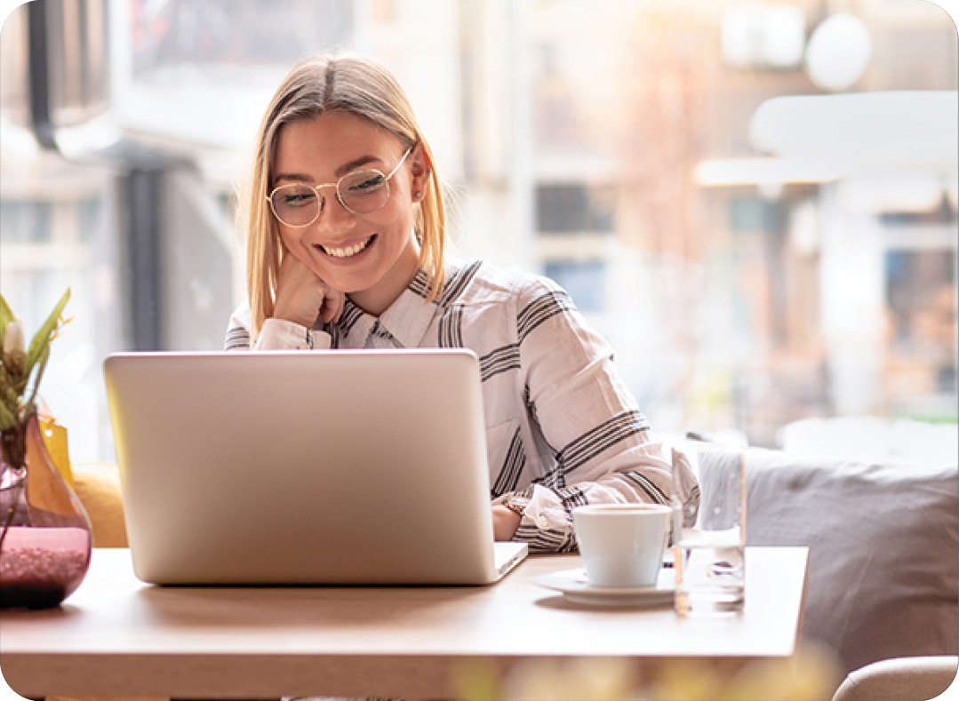 young woman using laptop at cafe