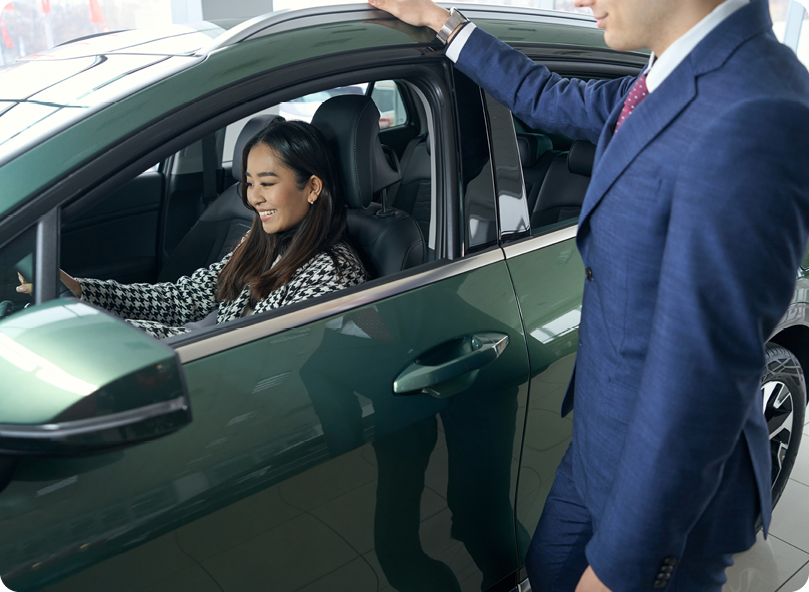 Woman smiling sitting in car.