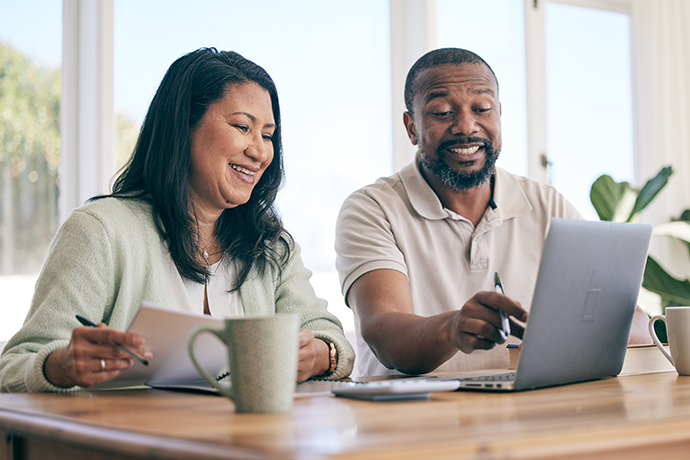 couple planning home finance, savings or mortgage and taxes together in the living room