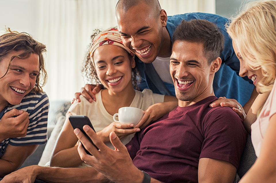 group of friends on couch laughing