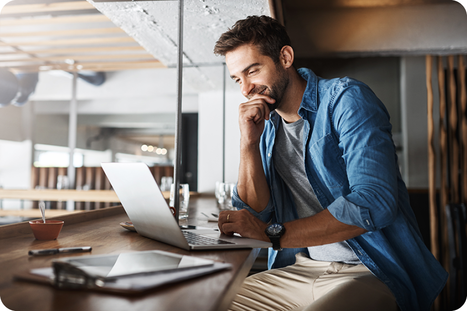 man sitting at desk on laptop