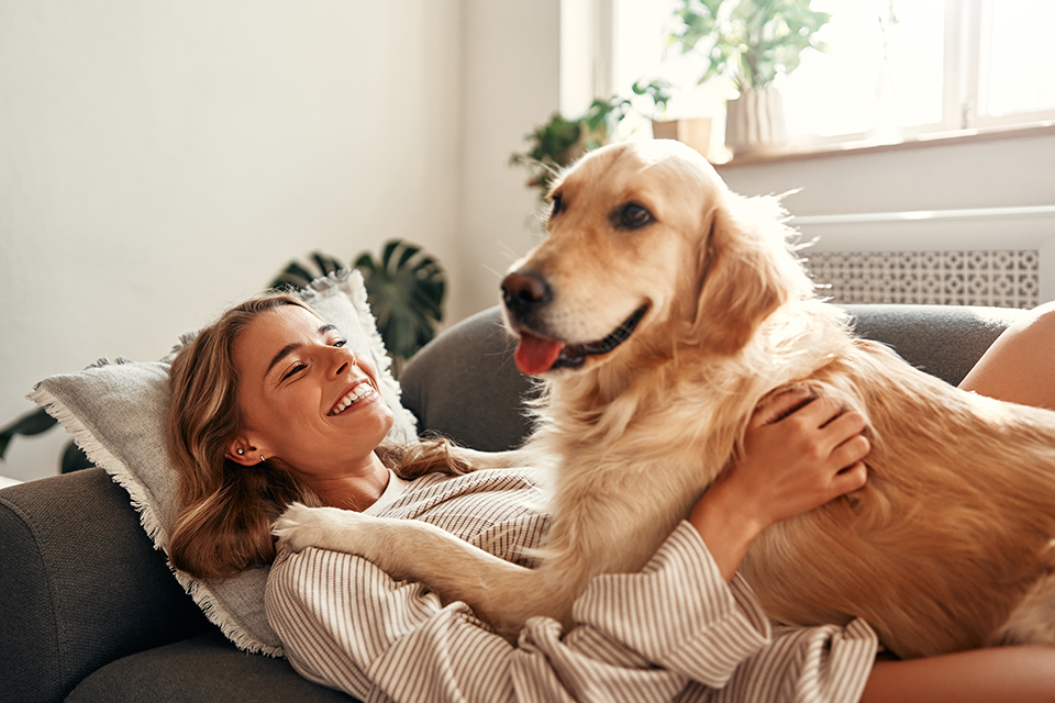 Women and dog relaxing on couch