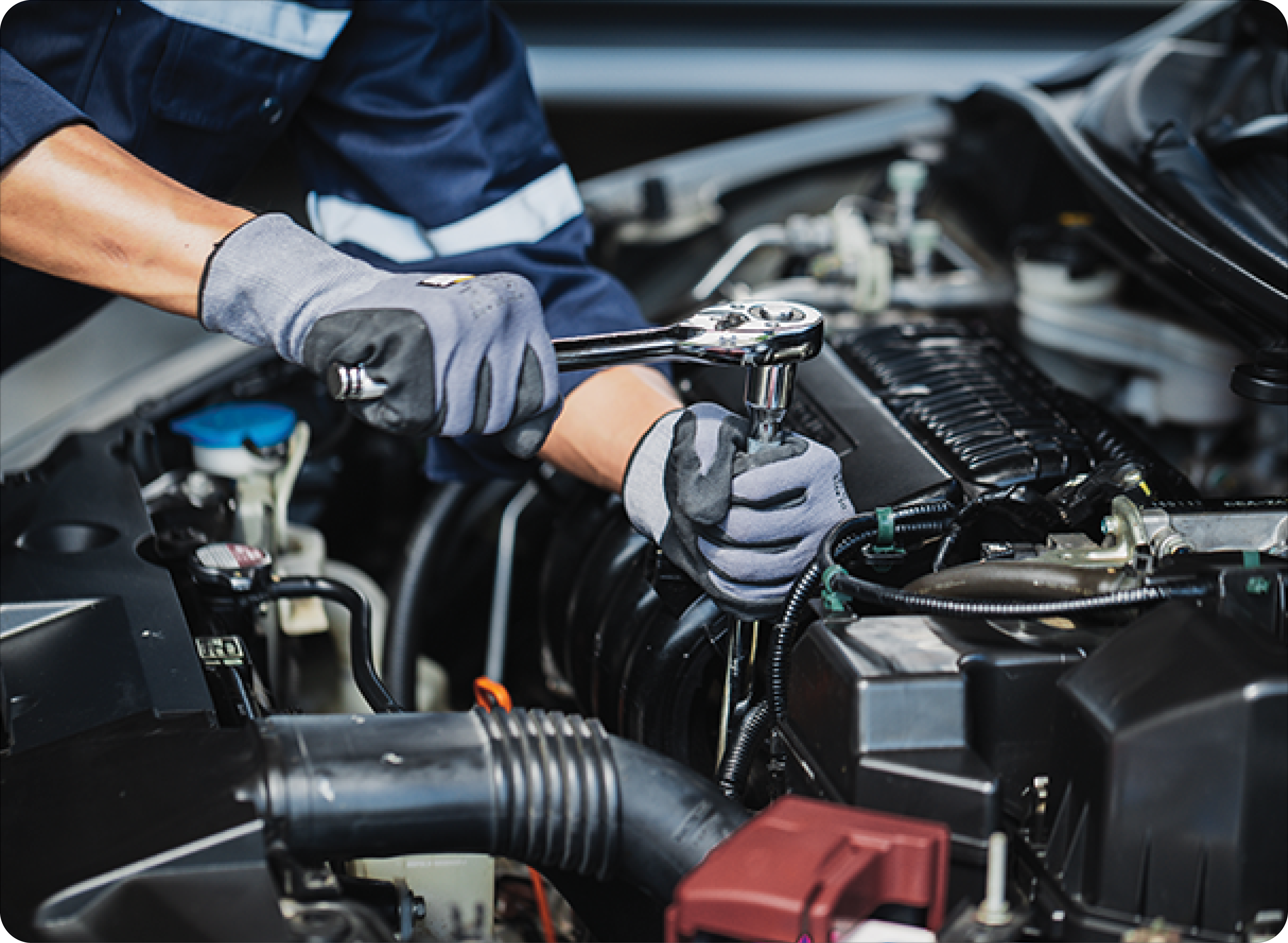 Professional mechanic working on the engine of the car in the garage