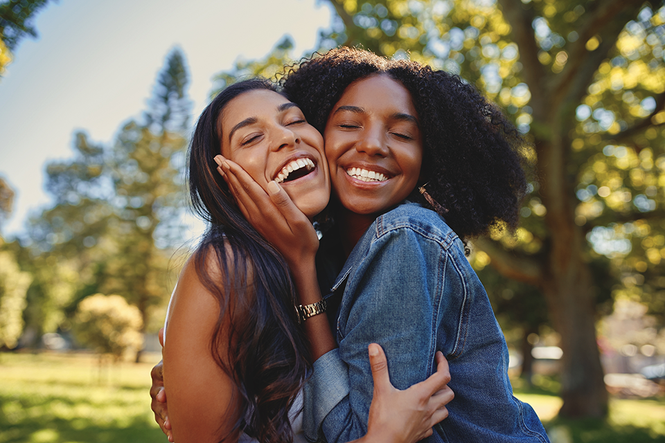 two best friends smiling and hugging